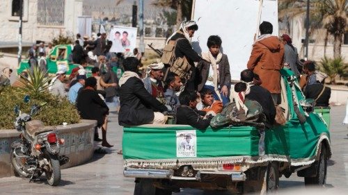 epa09677721 Houthi fighters ride vehicles carrying the coffins of slain comrades who were killed in ...