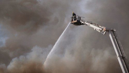 TOPSHOT - Firefighters are at work to extinguish a fire burning in the National Assembly, the main ...