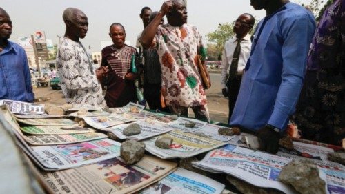 People gather at a newspaper stand after Nigeria government announced the lifting of Twitter ban, in ...