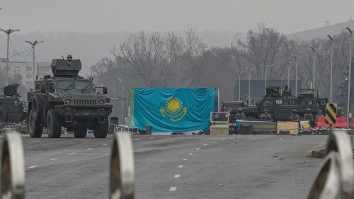 epa09676080 Kazakh militaries block a street during protests over a hike in energy prices in Almaty, ...