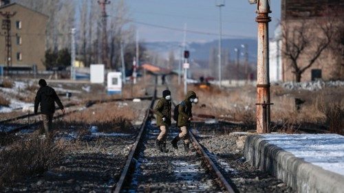 Boys walk on railtracks near Akyaka Train station on January 9, 2022 in Akyaka district of Kars ...