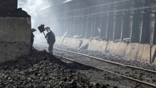 FILE PHOTO: A labourer works at a coke plant in the town of Avdiyivka near Donetsk, eastern Ukraine, ...
