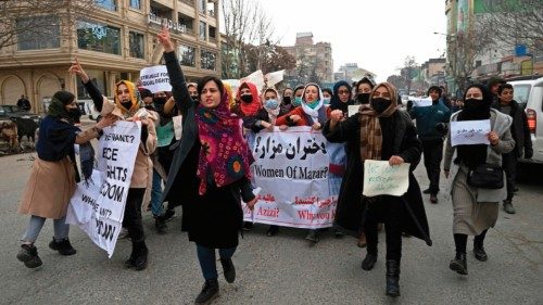 Afghan women march as they chant slogans and hold banners during a women's rights protest in Kabul ...