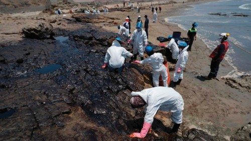 Cleaning crews work to remove oil from a beach in the Peruvian province of Callao on January 17, ...