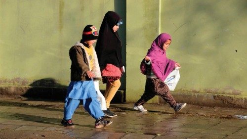 Children walk towards their school on the side of a road in Kandahar on January 19, 2022. (Photo by ...