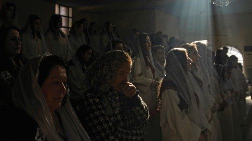 Christian worshippers attend a Christmas day mass at the Syriac Orthodox Church of Virgin Mary in ...
