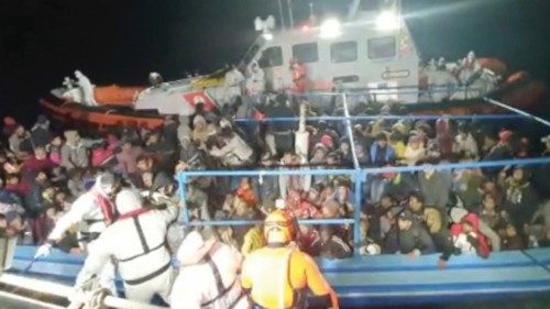 Migrants wait to be rescued by Italian coastguard during a search and rescue (SAR) operation off the ...