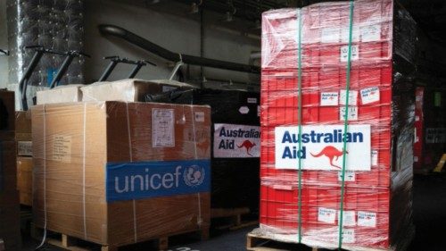 Pallets of humanitarian aid supplies are seen aboard HMAS Adelaide before the ship's departure to ...