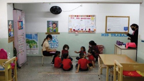 Children sit in a classroom at a primary school where attendance is down amid the spread of the ...