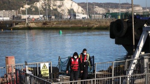 A migrant is brought into the Port of Dover by a Border Force worker after being rescued while ...