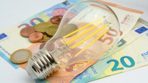 House energy cost theme with euro banknotes, coins and bulb isolated on white background House energy cost theme with euro banknotes, coins and bulb isolated on white background