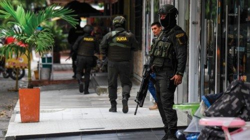 Members of Colombia's national police patrol the streets of Savarena, Arauca, Colombia, near the ...