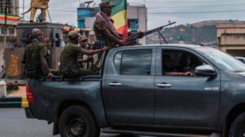 Members of the Amhara militia ride in the back of a pick up truck in the city of Gondar, Ethiopia, ...