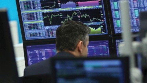 FILE PHOTO: FILE PHOTO: A trader works as screens show market data at CMC markets in London, ... FILE PHOTO: FILE PHOTO: A trader works as screens show market data at CMC markets in London, ...