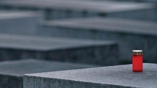 epa09712090 A single candle rests on on of the stele of the Memorial to the Murdered Jews of Europe, ...