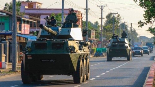 (FILES) In this file photo taken on February 3, 2021, soldiers ride in military armoured vehicles in ...