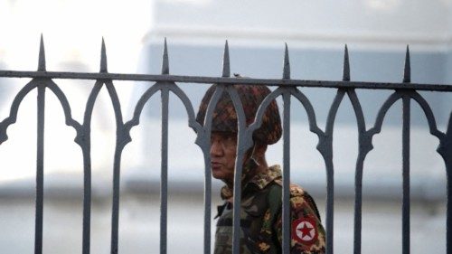 FILE PHOTO: A Myanmar soldier looks on as he stands inside city hall after soldiers occupied the ...