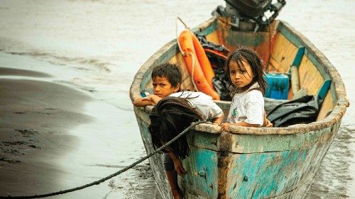 Children remain on a boat, after crude reached the Coca river due to an oil spill, in Puerto ...