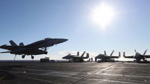 A military plane F/A-18 lands onboard aircraft carrier USS Harry S. Truman, in the Adriatic Sea, ...