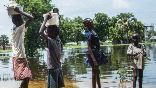 A family try to cross a flooded area after the Nile river overflowed after continuous heavy rain ...