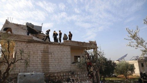 Emergency personnel work amid debris on a building destroyed in the aftermath of a counter-terrorism ... Emergency personnel work amid debris on a building destroyed in the aftermath of a counter-terrorism ...
