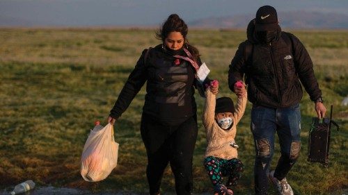 TOPSHOT - A family migrants cross illegally to Chile from bordering Bolivia, in Colchane, on ...