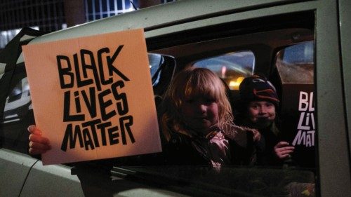 Children hold up Black Lives Matter signs during a protest for Amir Locke, a Black man who was shot ...