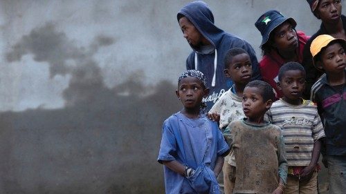 Locals stand next to a flooded area, as Cyclone Batsirai sweeps inland, in Fianarantsoa, Madagascar, ...