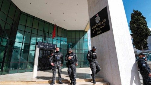 Members of the Tunisian security forces stand outside the closed entrance to the headquarters of ...