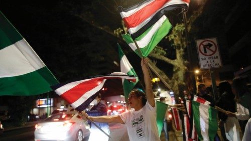 epa09734442 Supporters of political parties celebrate after the closing of polling stations in the ...