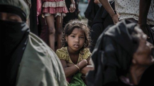 A young Rohingya girl who crossed the Naf river the previous night, waits to be transported to a ...