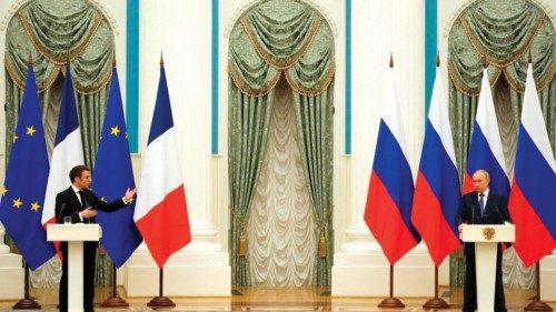 TOPSHOT - Russian President Vladimir Putin (R) listens during a joint press conference with French ...