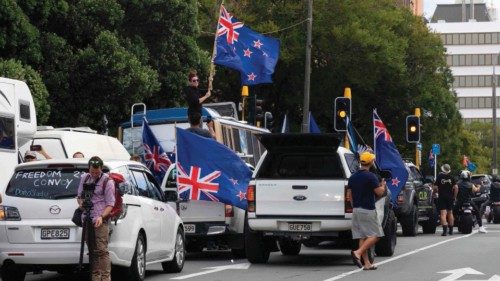 Protesters wave flags from vehicles parked on the streets outside the parliament building in ...