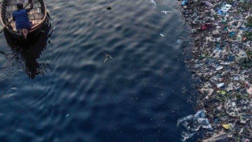 (FILES) In this file photo taken on January 21, 2020 a man paddles on a boat as plastic bags float ... (FILES) In this file photo taken on January 21, 2020 a man paddles on a boat as plastic bags float ...