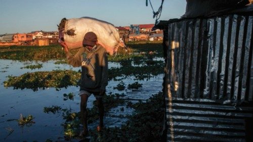 A resident walks in a flooded area of the 67-hectare Ankasina neighbourhood in Antananarivo on ...