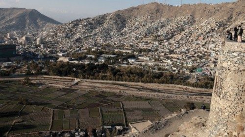 FILE PHOTO: Afghan men enjoy the general view of the city from the top of a hill in Kabul, ... FILE PHOTO: Afghan men enjoy the general view of the city from the top of a hill in Kabul, ...
