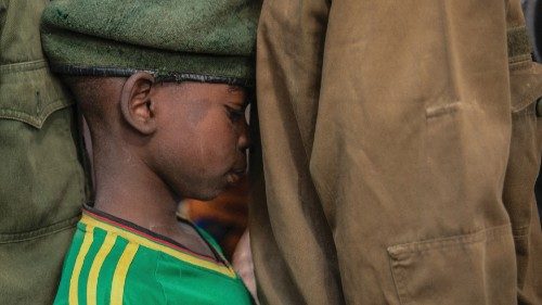 Newly released child soldiers wait in a line for their registration during the release ceremony in ...