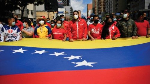 Nicolas Maduro, son of Venezuela's President Nicolas Maduro, holds on to a Venezuelan flag along ...