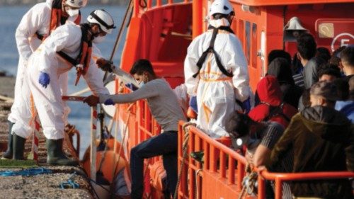 Migrants disembark from a Spanish coast guard vessel, in the port of Arguineguin, in the island of ...