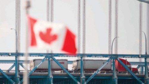 TOPSHOT - Tractor trailers drive across the Ambassador Bridge border crossing from Windsor, Ontario, ...