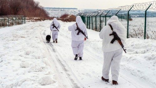 TOPSHOT - Ukrainian frontier guards walk along the border with Russia, some 40 km from the second ...