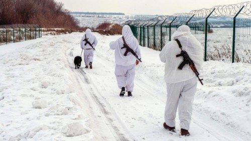 TOPSHOT - Ukrainian frontier guards walk along the border with Russia, some 40 km from the second ... TOPSHOT - Ukrainian frontier guards walk along the border with Russia, some 40 km from the second ...