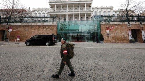 FILE PHOTO: A member of Austrian armed forces walks past Palais Coburg, the site of a meeting of the ... FILE PHOTO: A member of Austrian armed forces walks past Palais Coburg, the site of a meeting of the ...
