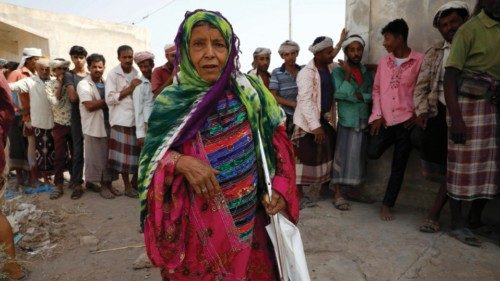 epa09750730 A Yemeni woman passes people waiting in queue to check their names on the lists of ... epa09750730 A Yemeni woman passes people waiting in queue to check their names on the lists of ...