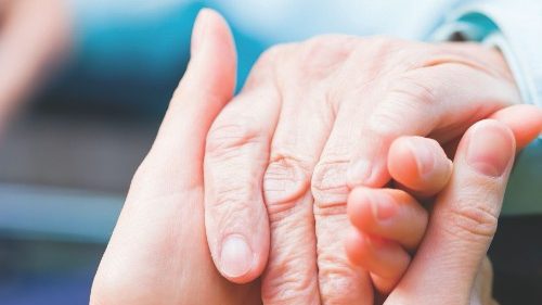 Young carer giving helping hands for the elderly woman