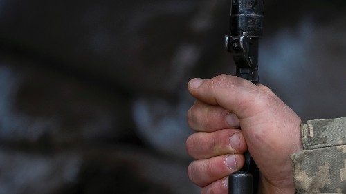 A Ukrainian service member holds a machine gun on the front line near the city of Novoluhanske in ...