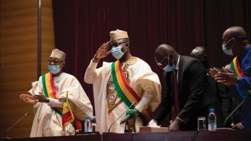 President of the National Transitional Council (NTC), Malick Diaw (C) salutes members of the council ...