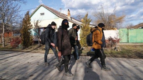 Migrants from Syria walk close to the border with Hungary and Romania in the village of Majdan, ...