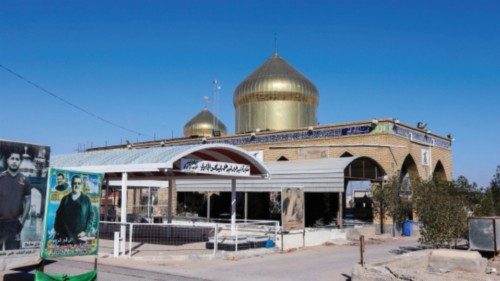 Tombs topped with two golden-coloured domes are pictured at the Wadi al-Salam cemetery, Arabic for ...