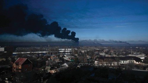 TOPSHOT - Black smoke rises from a military airport in Chuguyev near Kharkiv  on February 24, 2022. ...